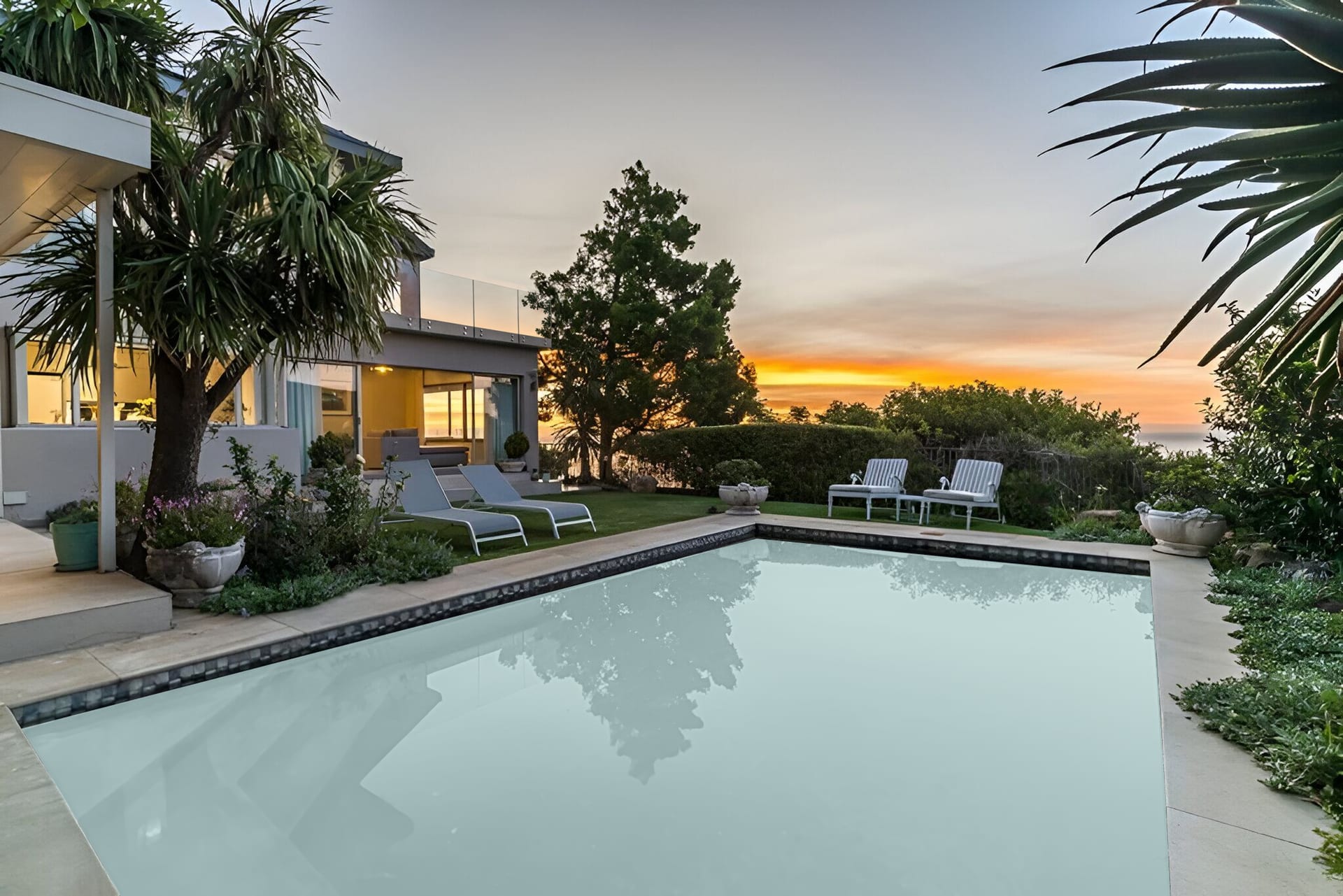 Everview at sunset, seen from the garden, with the Atlantic and Lion's Head behind the house